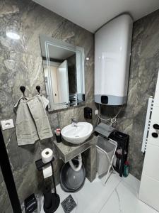 a bathroom with a sink and a mirror at Apartment Star 2 Ledine in Beograd +23 photos
