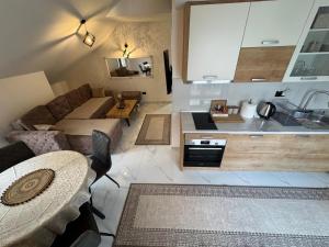 a living room with a couch and a kitchen at Apartment Star 2 Ledine in Beograd