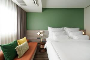 a bedroom with a bed and a couch at The Akyra Bangkok 11 in Bangkok +29 photos