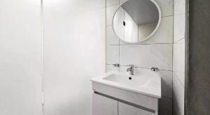 a white bathroom with a sink and a mirror at ZaZaHOTEL in Sosa