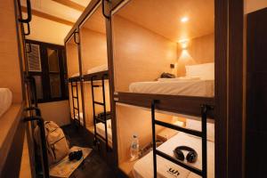 a small room with two bunk beds in it at Wink at Perak Road in Singapore