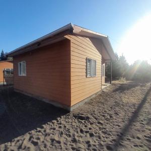 a small building on the side of a beach at Quillon cabañas in Quillón