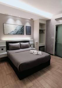 a bedroom with a large bed in a room at BOOKME HOTEL in Johor Bahru
