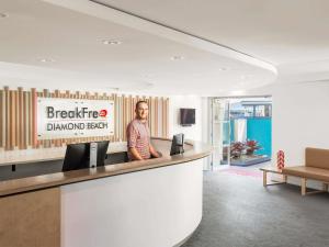 a man standing at a bar in a dental office at BreakFree Diamond Beach in Gold Coast +23 photos