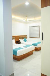 a bedroom with two beds in a room at Marine Grand Suite in Cochin