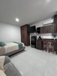 a living room with a bed and a kitchen at Casa Cerritos in Comitán +43 photos