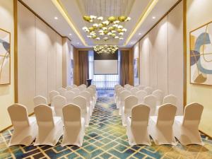 a conference room with white chairs and a projection screen at Mercure Mactan Cebu in Mactan +78 photos