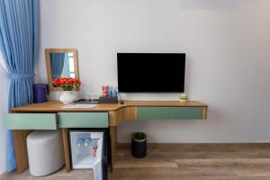 a desk with a computer monitor on top of it at Leono Coast Beach Hotel Phu Quoc in Phú Quốc