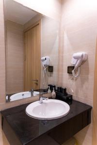 a bathroom with a sink and a mirror at Leono Coast Beach Hotel Phu Quoc in Phú Quốc