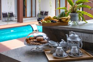 a tray of food on a table next to a pool at Chrisenbel Hideaway Retreat in Petaling Jaya +35 photos