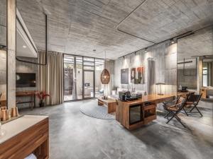 a large living room with a desk and a couch at Deer Chaser Hotel - Sun Moon Lake in Yuchi