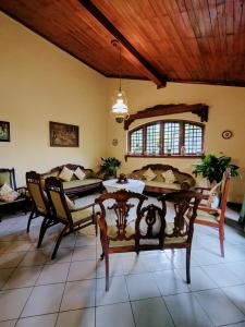 a living room with a table and chairs and a couch at Hill Crest Mansion in Kandy