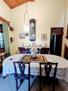 a dining room with a table with a vase on it at Hill Crest Mansion in Kandy