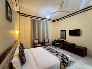 a hotel room with a bed and a desk at Farah Hotel Apartment in Muscat +28 photos