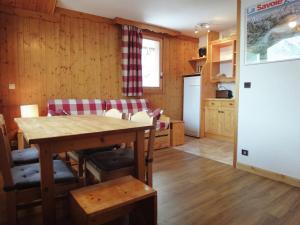 a kitchen and dining room with a table and chairs at Spacious flat in M ribel near the ski lifts in Méribel