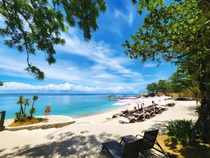 a beach with chairs and the ocean in the background at Mercure Mactan Cebu in Mactan