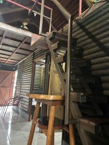 a wooden staircase in a room with a wooden wall at Cabaña Río Sarapiquí in Sarapiquí +4 photos