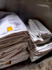 a pile of folded clothes sitting on the floor at IGN Residence Colombo in Colombo