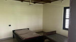 an empty room with a bed and a window at Zayas in Kundara