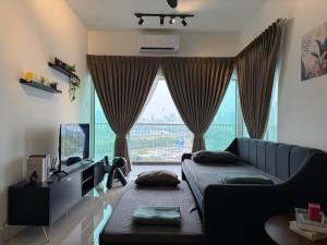 a living room with a couch and a large window at K&L Suites Razak City Kuala Lumpur in Kuala Lumpur +38 photos