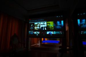 a tv in a dark room with a screen in the dark at Melon Hotel Tố Hữu in Trung Văn