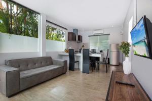 a living room with a couch and a table at 3 BR Pool Villa Lancelot in Rawai in Ban Saiyuan (1)