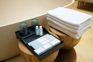 a tablet sitting on top of a stool with towels at Melon Hotel Tố Hữu in Trung Văn +23 photos