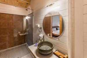 a bathroom with a sink and a mirror at Morii by the sea - Morjim Beach in Morjim