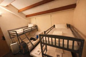 a room with two bunk beds and a suitcase at Wink at Perak Road in Singapore +21 photos