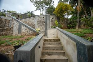 a set of stairs leading up to a stone wall at Villa Paranawatta in Unawatuna