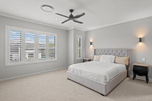 a bedroom with a bed and a ceiling fan at Spacious 4 Bed Home with Pool & Garden in Griffin