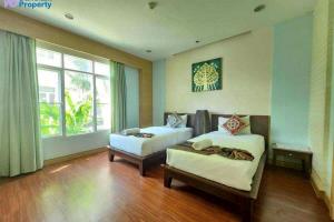 a room with two beds and a couch and a window at Hua Hin Blue Lagoon in Cha Am +262 photos