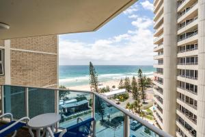 a balcony with a view of the beach and ocean at Grosvenor Beachfront Apartments Surfers Paradise in Gold Coast