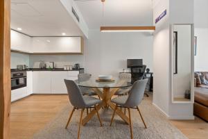 a kitchen and dining room with a table and chairs at Spacious 1 Bed Near Manly Beach in Sydney