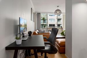 a living room with a desk and a couch at Spacious 1 Bed Near Manly Beach in Sydney