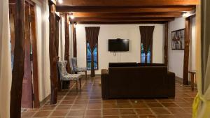 a living room with a couch and a tv at The Cove Pasikuda - Eco Retreat in Pasikuda