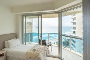 a bedroom with a bed and a view of the ocean at Grosvenor Beachfront Apartments Surfers Paradise in Gold Coast +77 photos