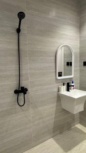 a bathroom with a shower and a sink and a mirror at شقة حي الوزارات in Riyadh +35 photos