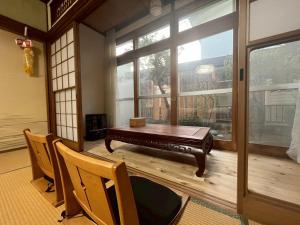 a room with a table and chairs and a large window at komorebi - Vacation STAY 19085 in Hakodate