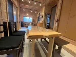 a dining room with a wooden table and benches at komorebi - Vacation STAY 19085 in Hakodate
