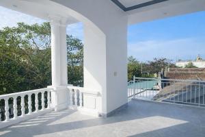 a white porch with a view of the ocean at Anh Dung Homestay in Ga Thừa Lưu
