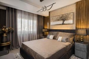 a bedroom with a large bed in a room at Blazer suite on the sea in Neoi Epivates