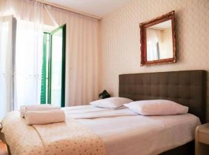 a bedroom with two beds with a mirror on the wall at Franov Butique Residence in Kali