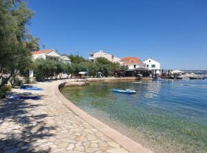 a body of water with a beach and some houses at Franov Butique Residence in Kali