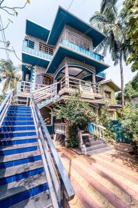 a house with stairs leading up to it at Marcelo Palace - Baga in Calangute