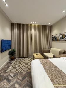 a hotel room with a bed and a couch at شقة حي الوزارات in Riyadh