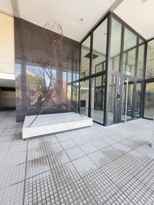 a large building with a sculpture in front of it at Tower Suites - Exclusiva Suite 9 - Centro de Neuquén in Neuquén