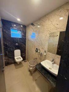 a bathroom with a sink and a toilet at Hotel Mahabaleshwar Mount View in Mahabaleshwar +74 photos
