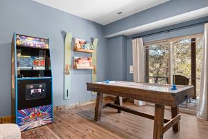 a room with a pool table and a pinball machine at Timberline Hideaway with Hot Tub in Hollister