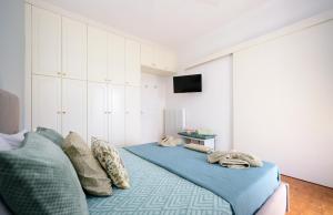 a bedroom with a bed with blue sheets and pillows at Corfu SKYLINE RESIDENT 360 in Corfu